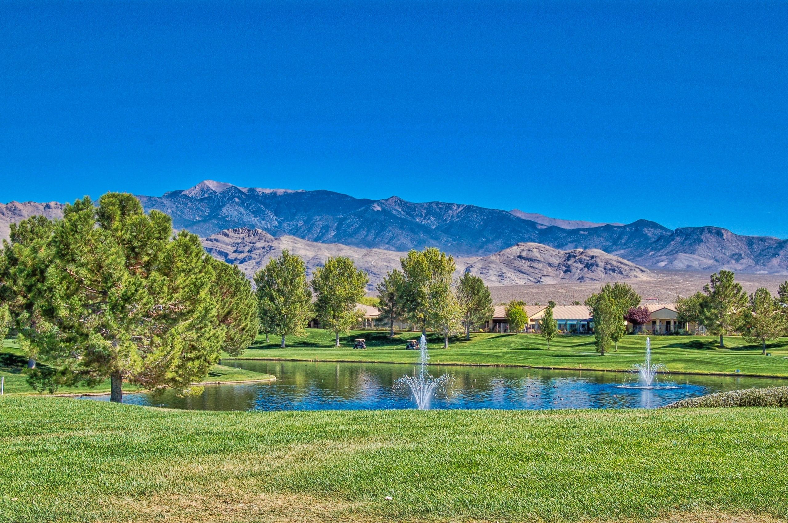 Pahrump landscape with mountains, trees, and a pond